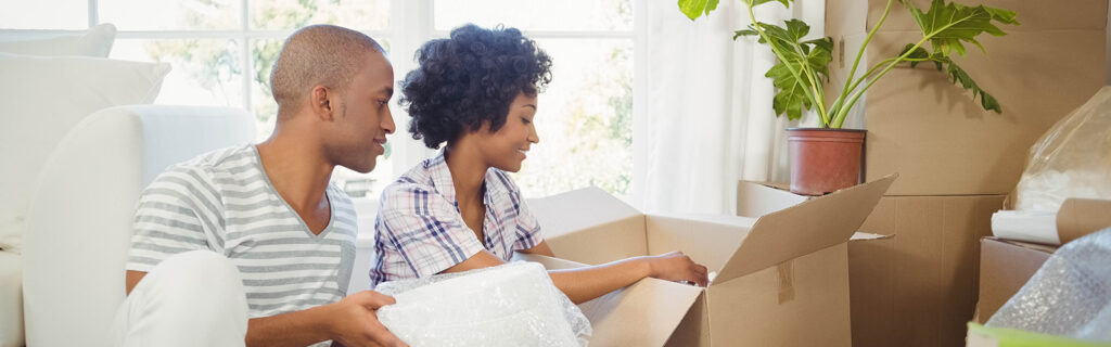 young couple unpacking into new home